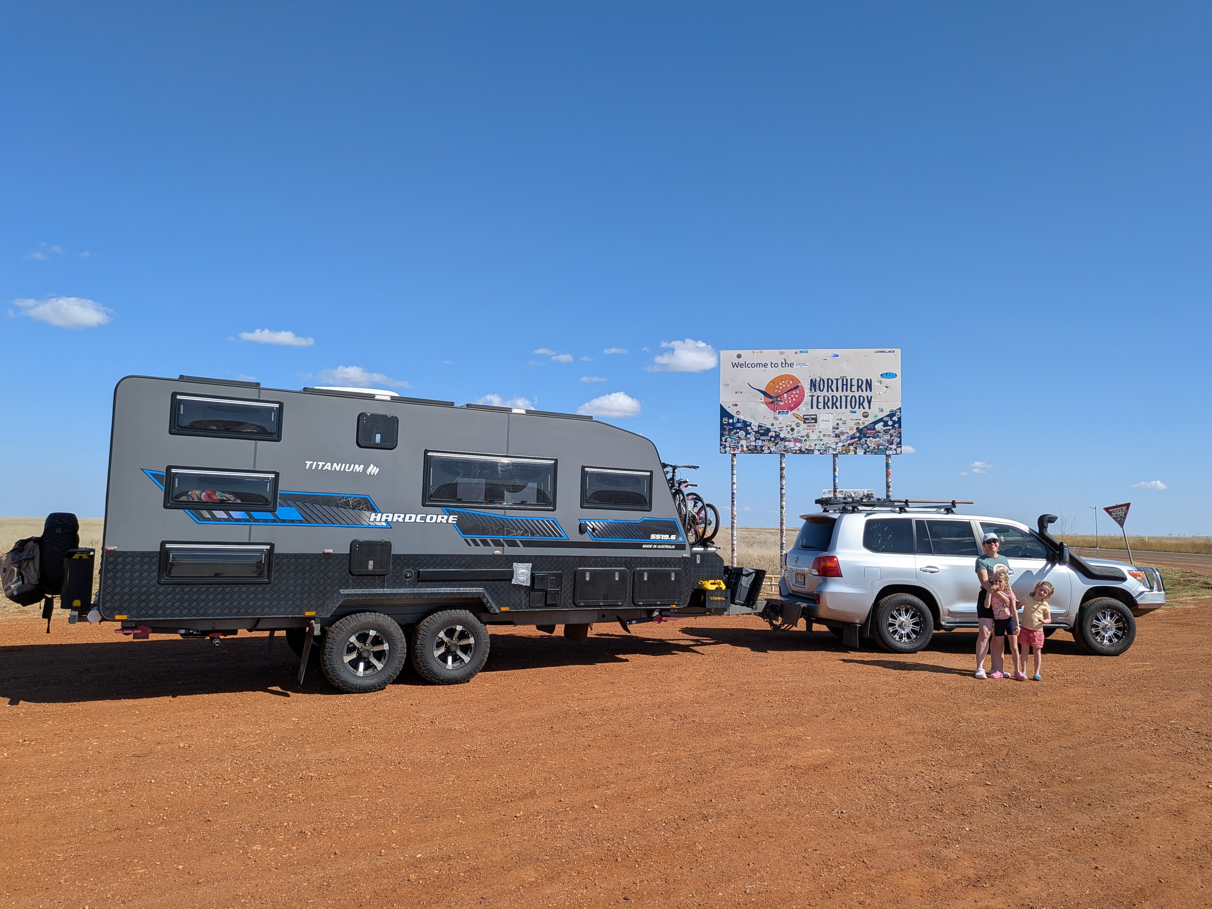 Reg and TITANIUM HARDCORE at the Welcome to the Northern Territory sign on red dirt