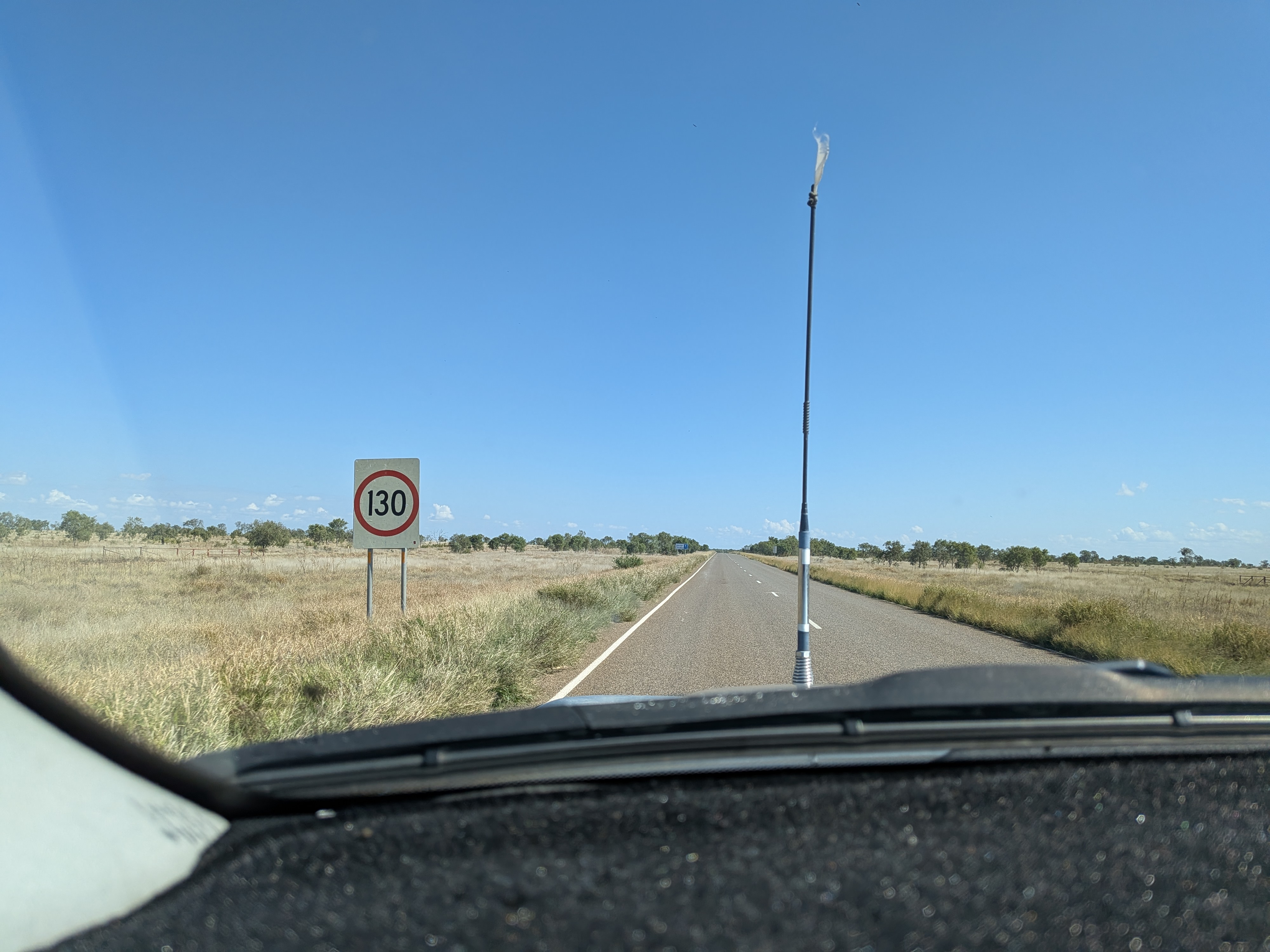 130 speed limit sign on a straight NT highway