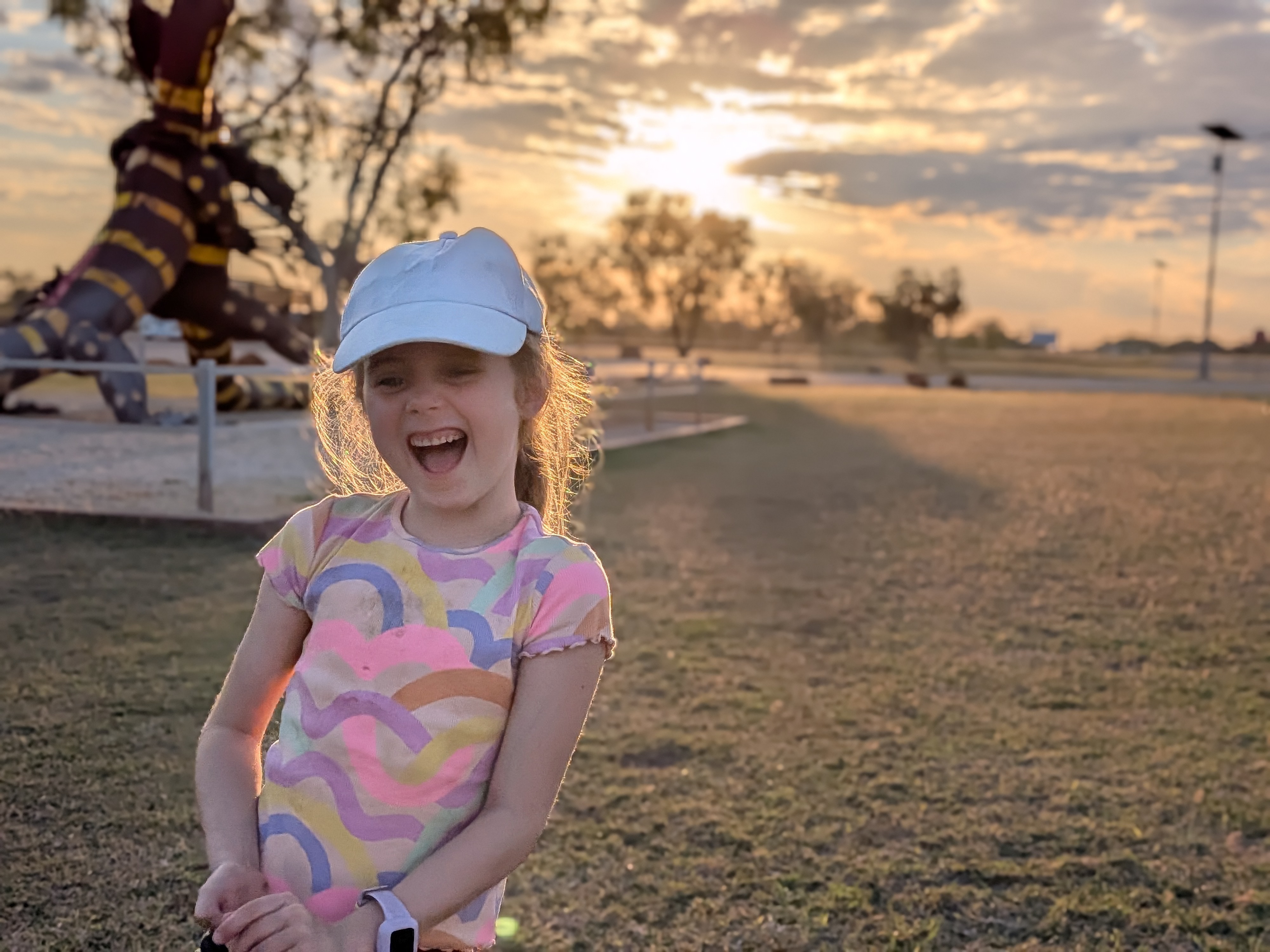 Hazel laughing at sunset by the goanna sculpture