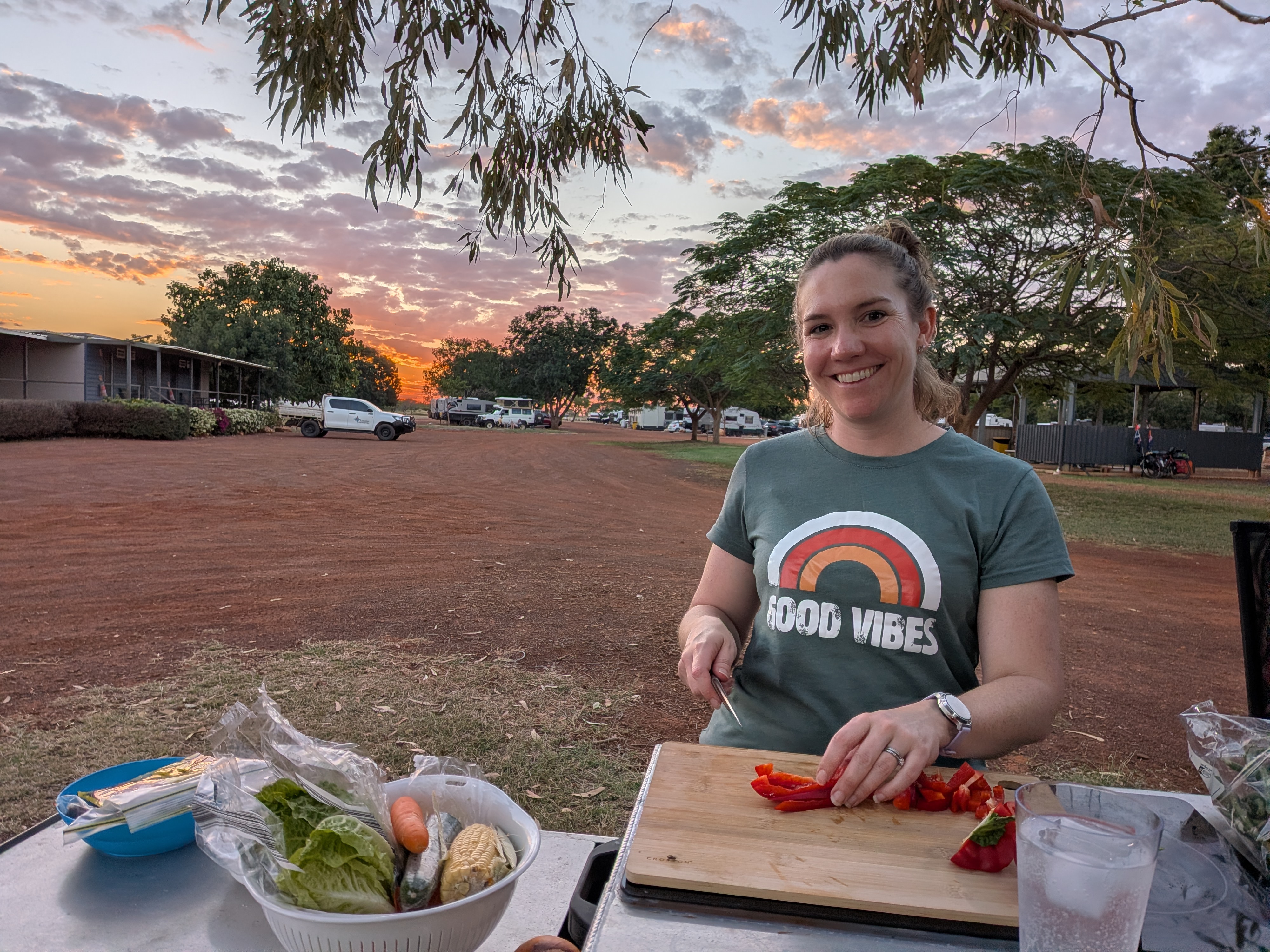 Erin making dinner at sunset — Good Vibes t-shirt