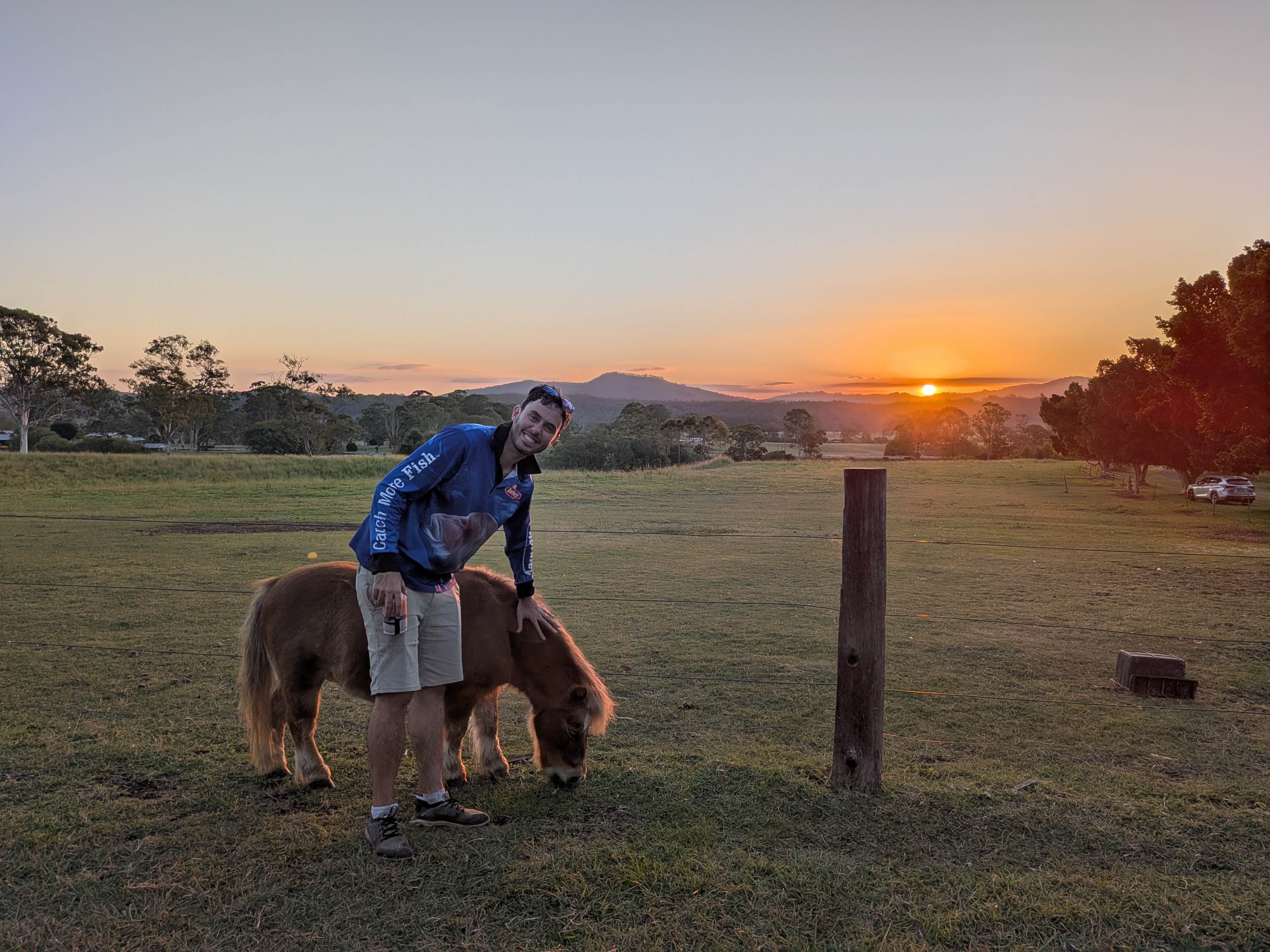 Dylan with a miniature pony at sunset